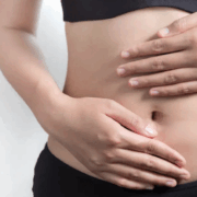 photo gros plan sur deux mains sur ventre plat et mince de femme